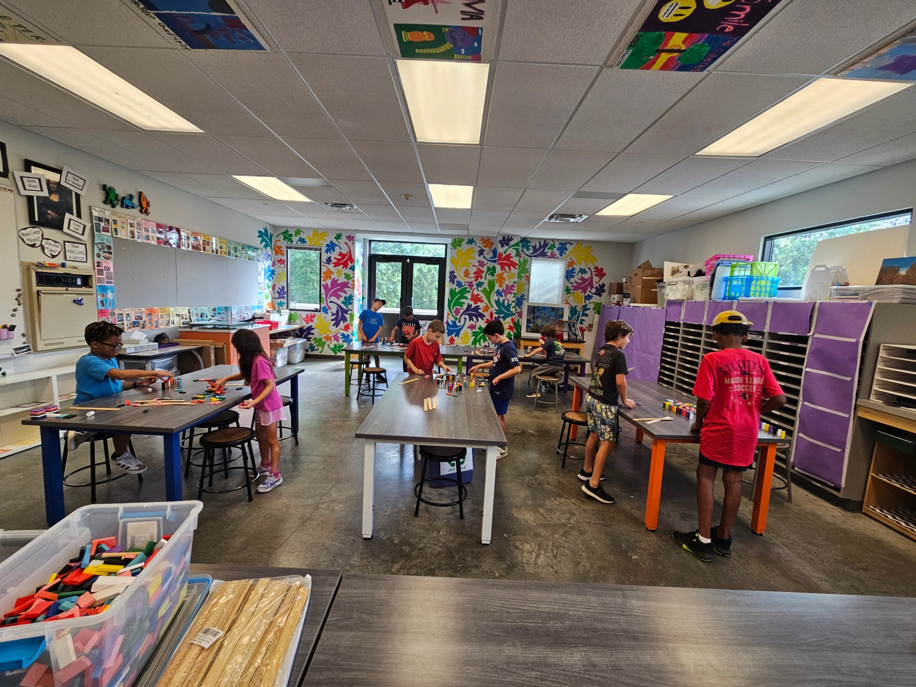 Club members designing at classroom tables