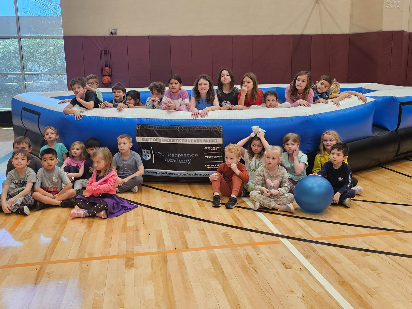 Recreation Academy campers gathered together in a gym