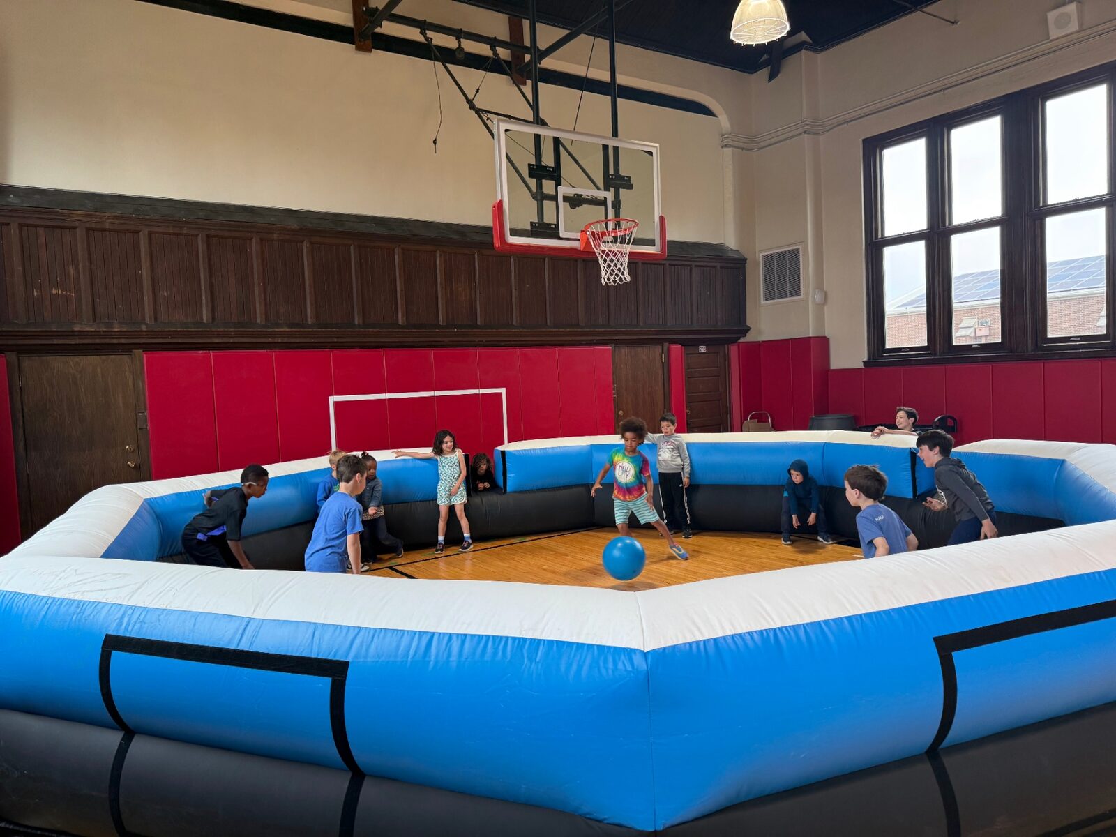 Campers playing in a gym-sized inflatable ga-ga pit