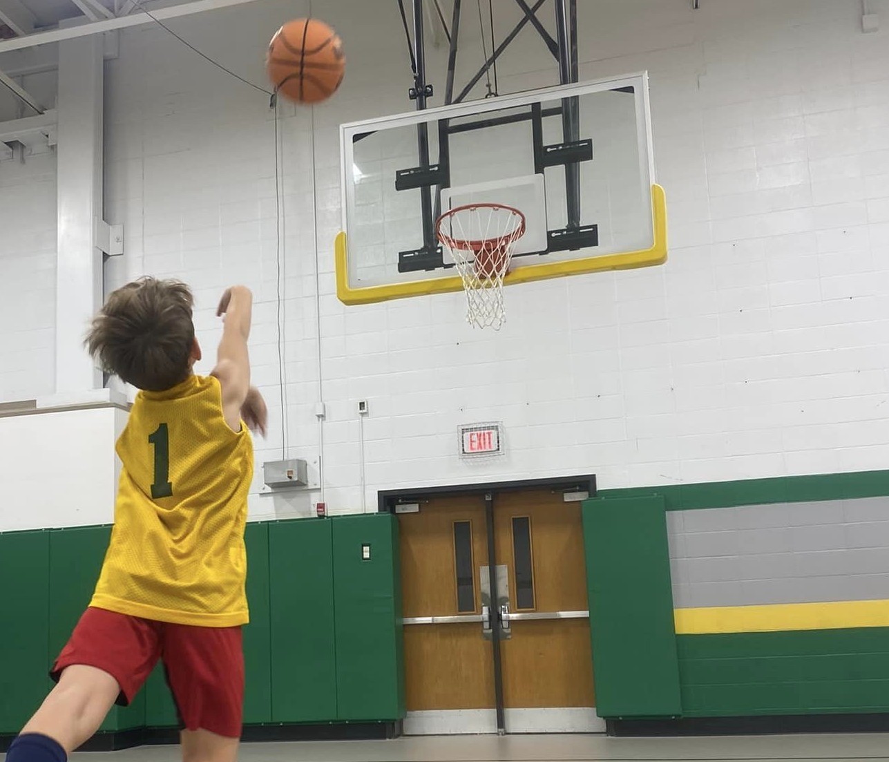 A Recreation Academy coach running a basketball drill