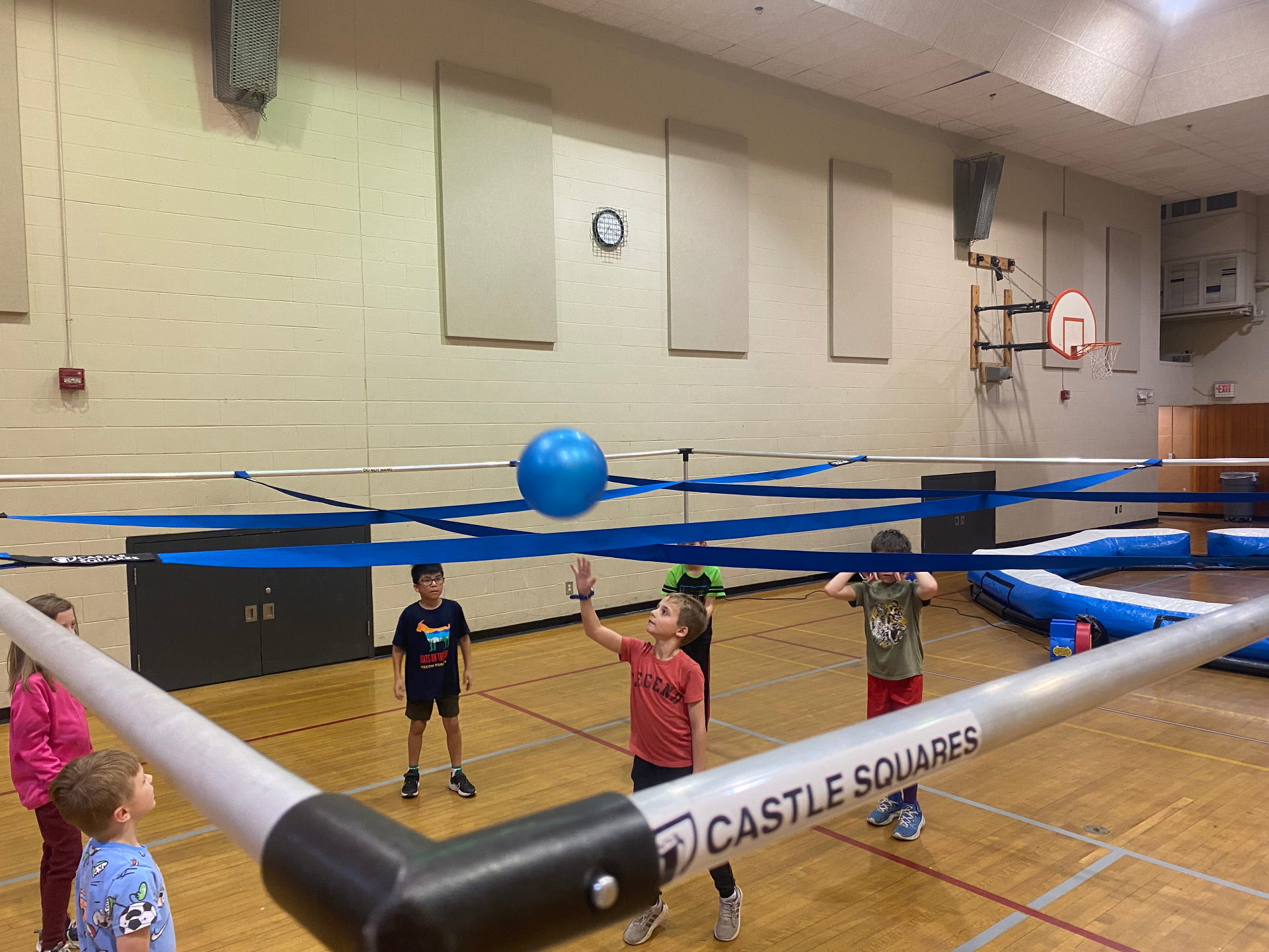 Kids playing 9 Square in the Air in a gym