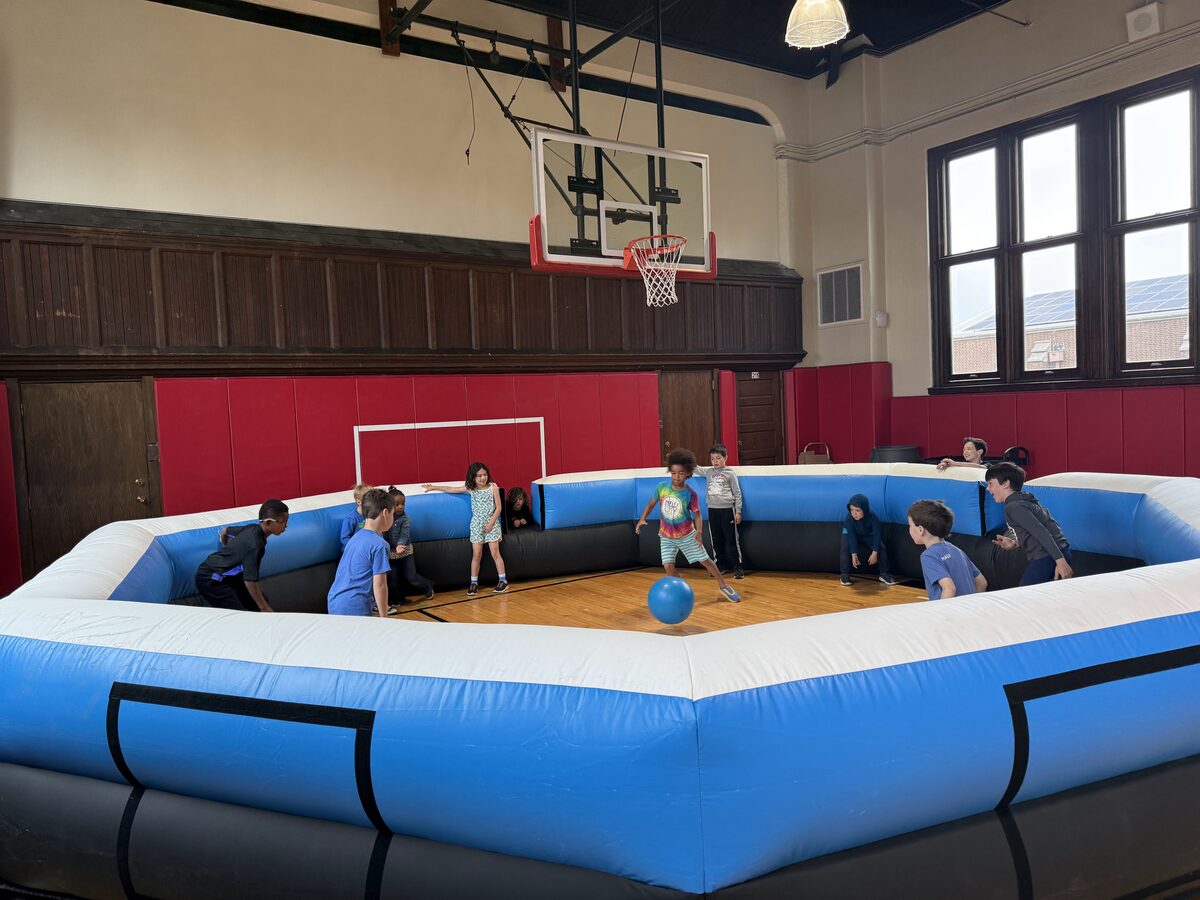 Campers playing gaga ball inside an octagon pit at a Rec Academy camp